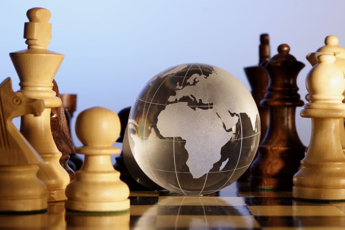 Chess pieces and globe